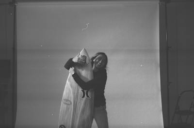 A black and white still image of surfer Carissa Moore from the film RISS.