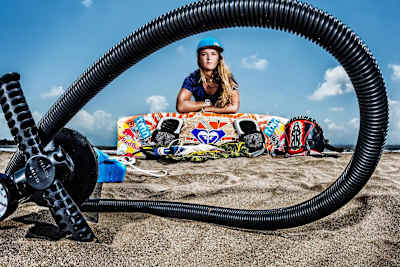 La jeune kitesurfeuse pro portugaise Inès Correia sur la plage avec sa board de kitesurf à Mumbai.