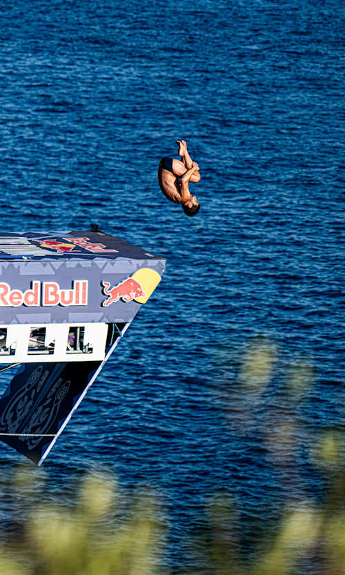 In 2024, Carlos Gimeno somersaults off the Red Bull Cliff Diving platform in Antalya