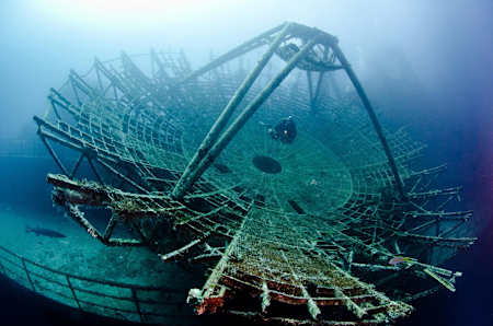 A Diver diving through the ship’s huge satellite.