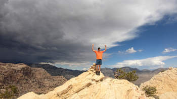A climber celebrates at the summit in a shot from Reel Rock S9 E3