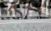 A Wings For Life World Run banner on a barricade with runners passing by