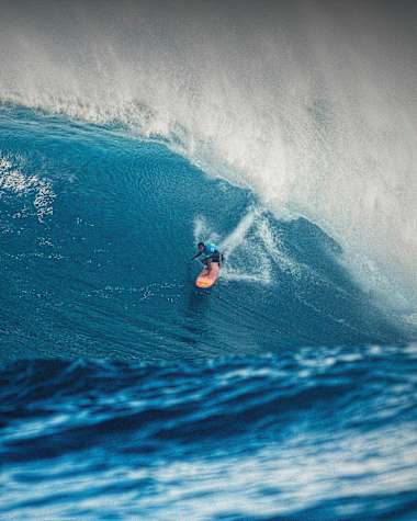 A surfer rides Jaws in Maui, USA.