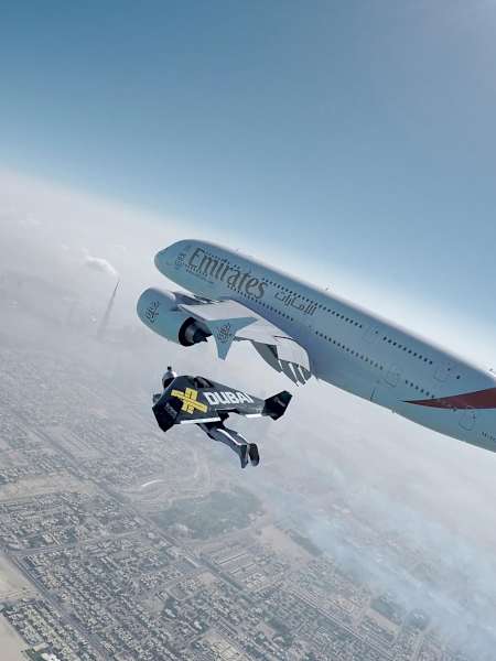Jetmen Yves Rossy and Vince Reffet fly next to an Airbus 