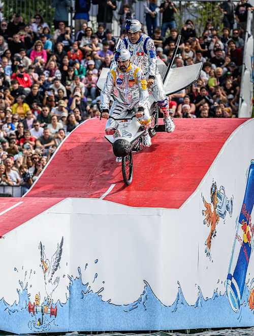 On September 14, 2025, a tandem bike team rides down the colourful ramp of the Red Bull Tandem Splash in Lausanne, Switzerland, thrilling the crowd with their adventurous stunt