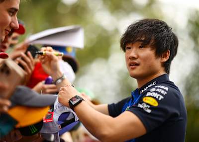 Yuki Tsunoda signs autographs for fans on the Melbourne Walk prior to final practice ahead of the F1 Grand Prix of Australia at Albert Park Grand Prix Circuit in March 2026. 