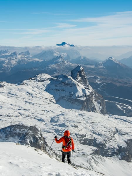 A hiker descending Piz de Puez in the Dolomites, Italy