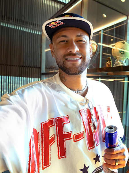 Neymar Jr. stands in front of his collection of football memorabilia for the filming of his show Neymar Jr. Full Access