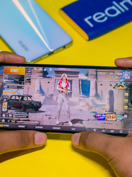 A gamer plays PUBG Mobile on a realme phone.