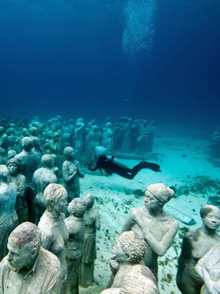 A diver exploring the underwater Sculpture Park at Cancun in Mexico.