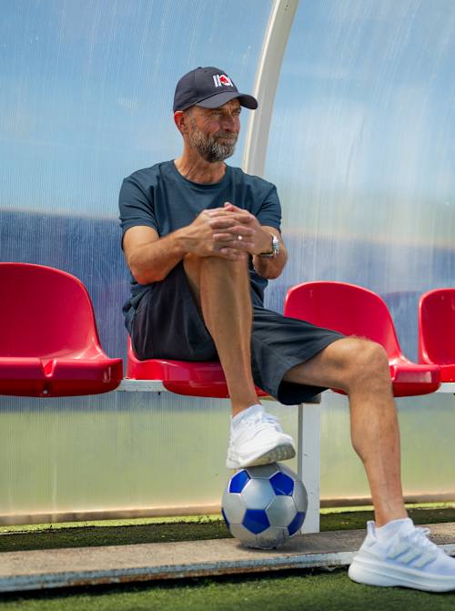 Jürgen Klopp sits in a dug-out during the Red Bull Ultimate Football Challenge in Ibiza on May 23, 2026.