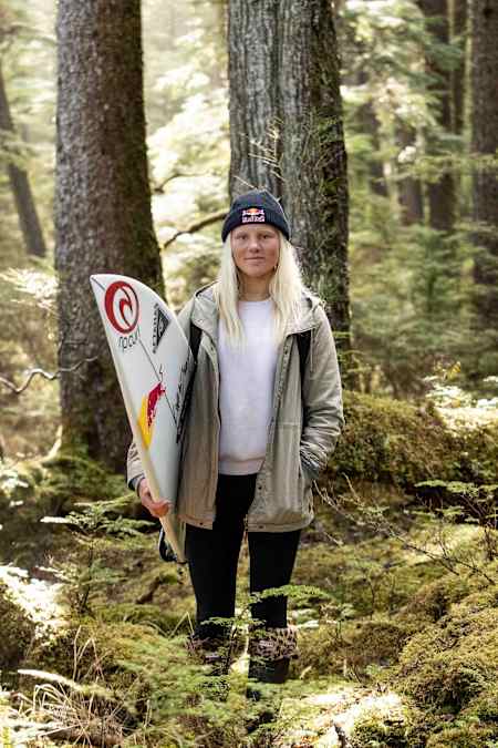 Canadian surfer Mathea Olin poses in the old growth forest on Haida Gwaii.