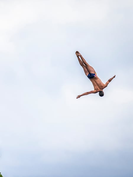 In 2024, Aidan Heslop plunges from Kinbane Castle cliff during the Red Bull Cliff Diving World Series.