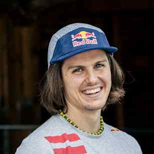 Domen Škofic poses beside aircraft during the Red Bull Plane Climb Project in Niederöblarn, Austria, on 23 August 2025.