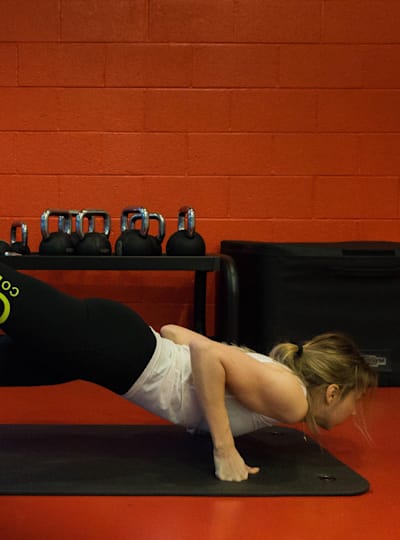 A mountain biker does a push-up with twist variation.