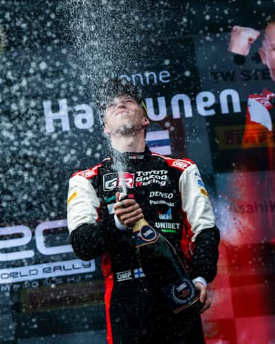 Kalle Rovanperä toasts the World Rally Championship at Rally New Zealand in Auckland.