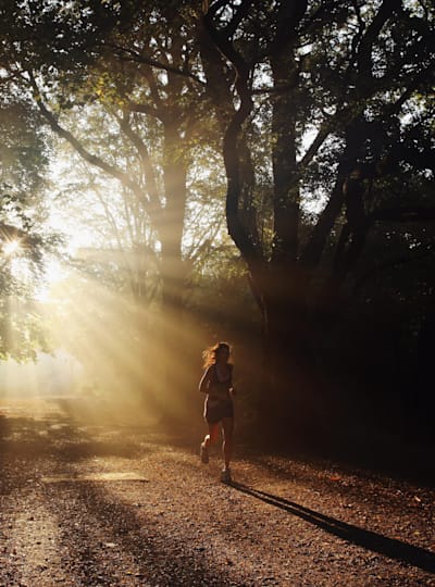 Woman trail running in Hampstead Heath