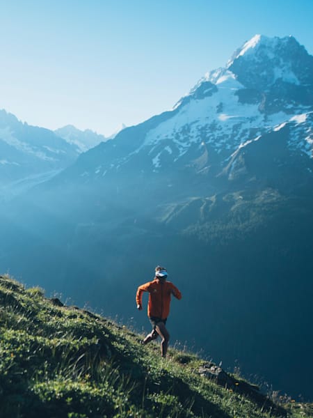 Running against an alpine mountain backdrop with mountain goats.