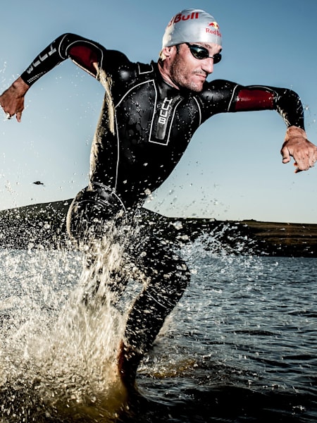 An image of a triathlete exiting the water during competition.