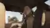Screenshot from the GTA 6 trailer shows Lucia Caminos with a red scarf and a wad of money in her hand. 