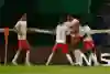 RB Leipzig players celebrate the winning goals scored by Tyler Adams in their Champions League quarter-final match against Atletico Madrid.