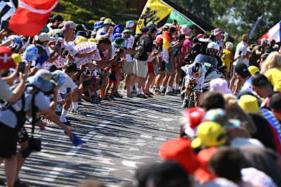 Remco Evenepoel of Red Bull - BORA - hansgrohe competes while fans cheer during his Stage 16 victory at the 113th Tour de France. 