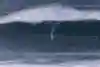 In 2025, Justine Dupont surfing a massive wave at Nazaré during the TUDOR Nazaré Big Wave Challenge. 