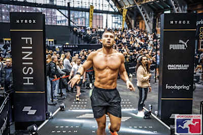 Jake Dearden crossing the finish line at a HYROX event