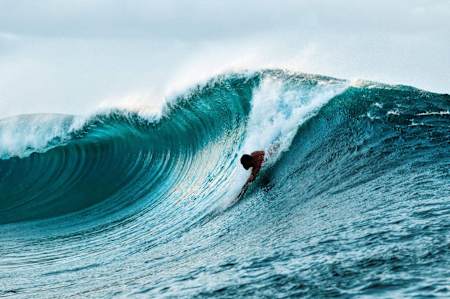 Chris Kalima drops into a massive wave