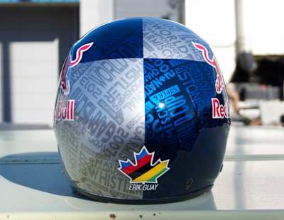 Final touches on the custom Red Bull helmet for Eric Guay by Stacy Glaser