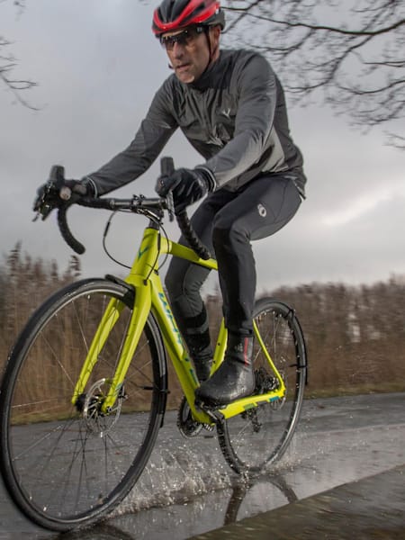 Cyclist on wet road riding Whyte Wessex One.