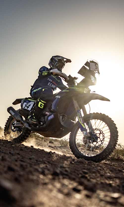 In 2024, Harith Noah races his motorbike at Rally Du Maroc in Morocco, kicking up dust on the desert terrain.