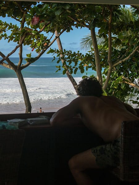 Australian pro surfer Julian Wilson checks the surf at Pipeline in Hawaii