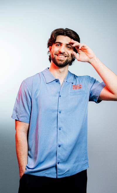 Ali 'SypherPK' Hassan poses for a studio portrait in Red Bull-branded apparel.    