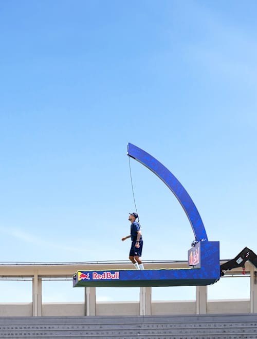Two football stars take part in Jürgen Klopp's Pro Footballers vs Impossible 100 Ball Challenge 2026, suspended high in the air kicking a football