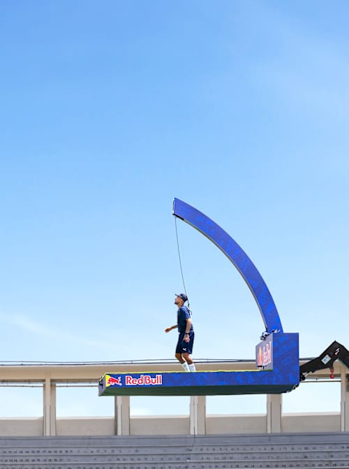 Two football stars take part in Jürgen Klopp's Pro Footballers vs Impossible 100 Ball Challenge 2026, suspended high in the air kicking a football