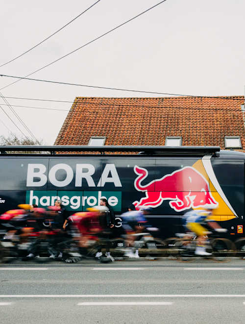 Red Bull – BORA – hansgrohe riders, including Jordi Meeus and Laurence Pithie, race past the iconic team bus during the 78th Kuurne - Brussel - Kuurne in Belgium, March 2026