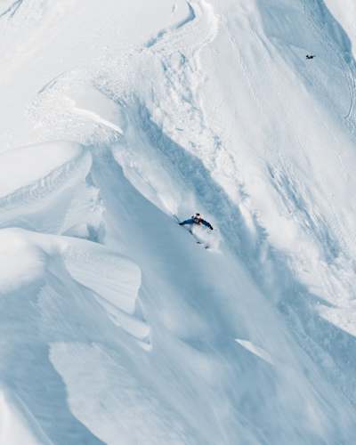 Michelle Parker carves through deep Alaskan powder at Red Bull Natural Selection 2025, showcasing fearless riding against dramatic snowy terrain in Alaska, United States