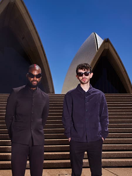 Genesis Owusu and Alex Turley pose for a portrait in front of the Sydney Opera House in Sydney, Australia on December 13, 2022.  