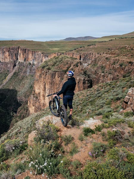 Mountain bike rider Matt Jones looks out over a canyon in Lesotho.