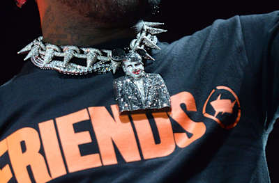 A photo of rapper Lil Uzi Vert performing live while wearing his Marilyn Manson jewellery detail.