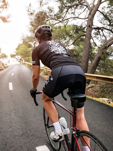 A cyclist rides up a road climb.