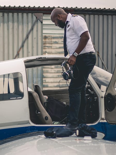 An instructor from the iFly Academy shows school students around a small plane.