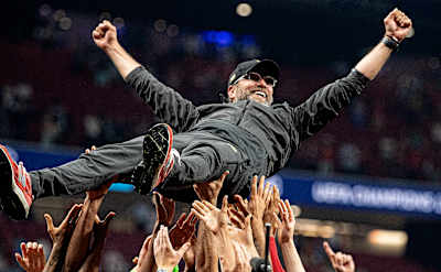 Jürgen Klopp is lifted up as Liverpool celebrate winning the UEFA Champions League in Madrid.