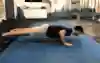 An athlete does a push-up in the gym.