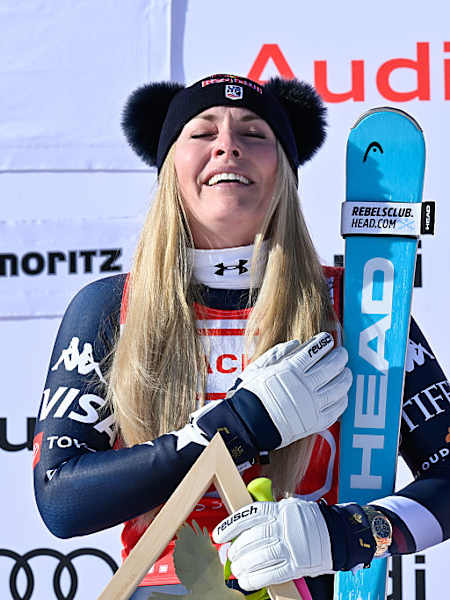Lindsey Vonn listens to the US national anthem after winning the downhill race at the FIS Alpine Skiing World Cup in St Moritx, Switzerland on December 12, 2025.