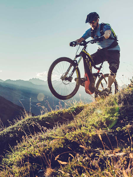 eMTB rider in Ötztal alpine valley, Austria.