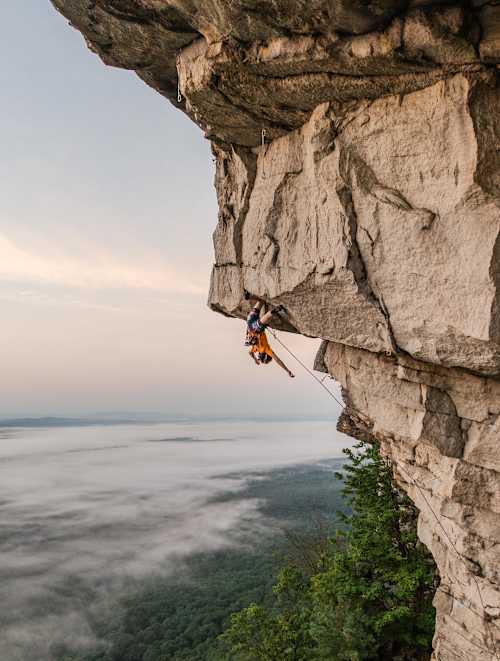 Climber Will Moss scales a sheer cliff edge at The Gunks, Shawangunk Mountains, New York state, United States (Reel Rock)