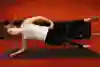Demonstration of person doing a banded side plank with leg lift.