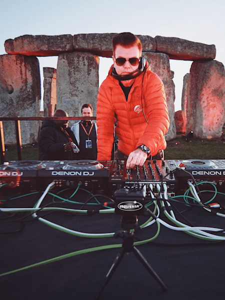 A photo of UK club legend Paul Oakenfold performing a set at Stonehenge, in the UK.